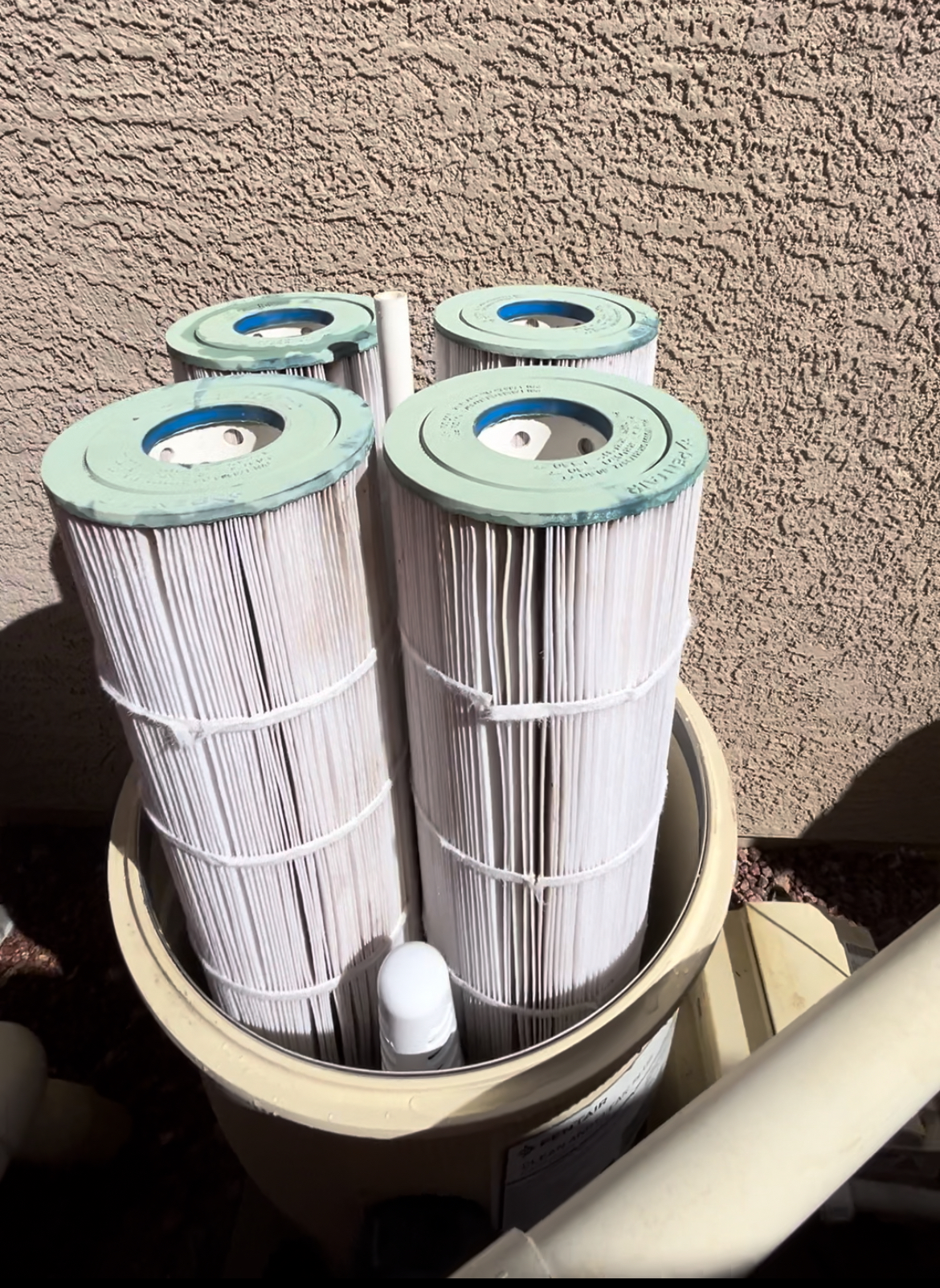 Clean white Pentair filter cartridges in their housing after cleaning