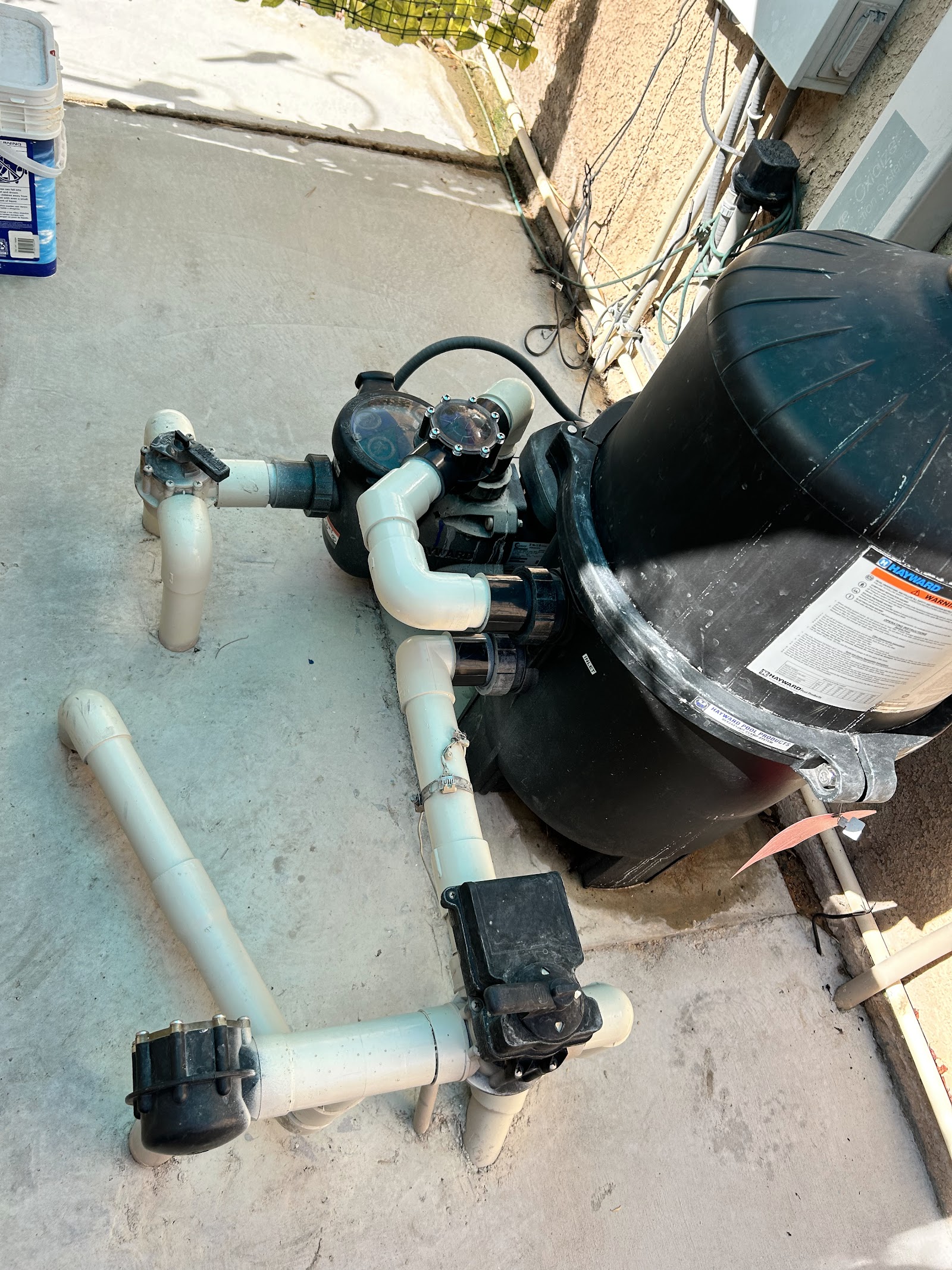 Hayward pool filter and pump plumbing system on a concrete pad